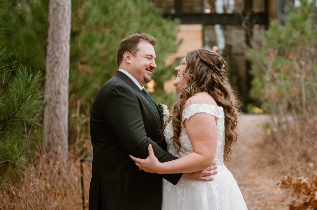 Bride and groom laughing on wedding day